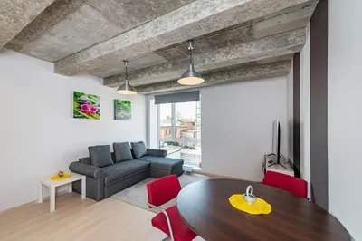 a living room with a table and a couch at Apartment Accent by Polo Apartments in Kaunas