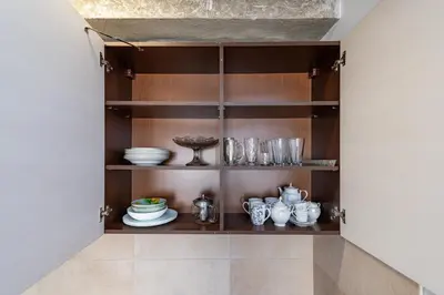 a cupboard with plates and dishes on it at Apartment Accent by Polo Apartments in Kaunas