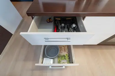 an open drawer in a kitchen counter withtools at Apartment Accent by Polo Apartments in Kaunas