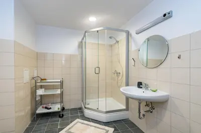 a bathroom with a shower and a sink at Apartment Accent by Polo Apartments in Kaunas