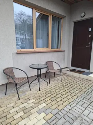 two chairs and a table on a patio at Bistrycia in Vilnius