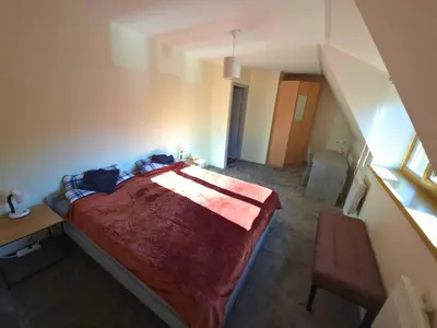 a bedroom with a bed and a desk and a staircase at Bistrycia in Vilnius