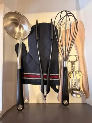 a bunch of kitchen utensils sitting on a table at Crown Apartment Park View in Ukmergė