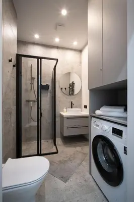 a bathroom with a shower and a washing machine at Cozy 4 Two - City Center Apartment in Kaunas