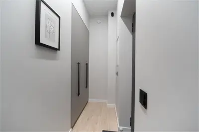 a hallway of a house with white walls and wood floors at Cozy 4 Two - City Center Apartment in Kaunas