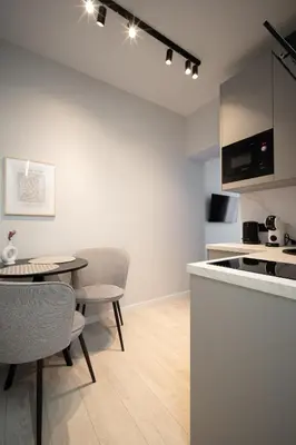 a kitchen and dining room with a table and chairs at Cozy 4 Two - City Center Apartment in Kaunas