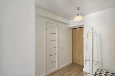 a white room with a closet and a door at Aqua apartment in Druskininkai