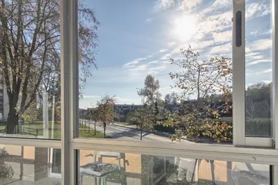 an open window with a view of a park at Aqua apartment in Druskininkai
