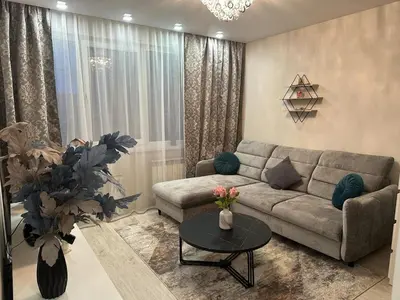 a living room with a couch and a table at Newly renovated cosy apartment near scenic river in Jonava