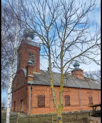 a brick building with a clock tower on top of it at Newly renovated cosy apartment near scenic river in Jonava