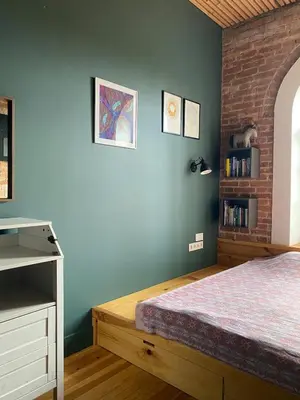 a bedroom with a bed and a blue wall at Train Home #3 in Pakopi