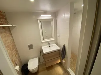 a bathroom with a sink and a toilet and a mirror at Train Home #3 in Pakopi