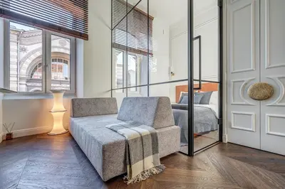 a living room with a couch and a bed at New! Design OLD TOWN apartment in Vilnius