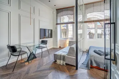 a living room with a bed and a glass table at New! Design OLD TOWN apartment in Vilnius