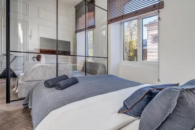 a bedroom with a large bed with two pillows on it at New! Design OLD TOWN apartment in Vilnius