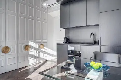 a kitchen with a glass table with a bowl of fruit at New! Design OLD TOWN apartment in Vilnius