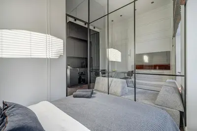 a bedroom with a bed and a mirror at New! Design OLD TOWN apartment in Vilnius