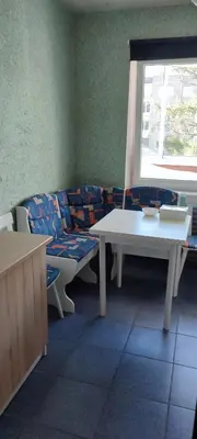 a room with two tables and a couch and a window at CheapStayVilnius in Vilnius