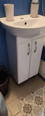a bathroom with a white sink and a blue wall at CheapStayVilnius in Vilnius