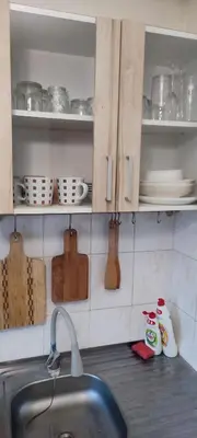 a kitchen counter with a sink and plates and utensils at CheapStayVilnius in Vilnius