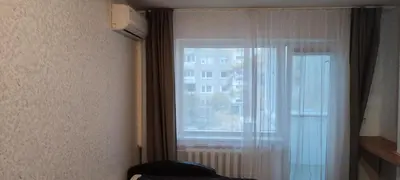 a room with a window with a curtain and a window at CheapStayVilnius in Vilnius