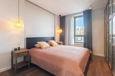 a bedroom with a large bed and a window at Terrace Apartment near Ozas in Vilnius