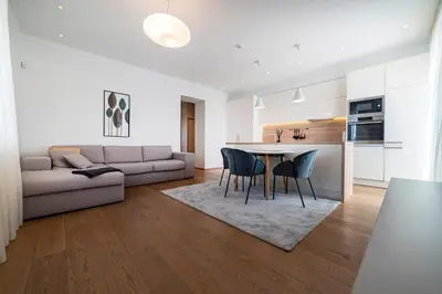 a kitchen and living room with a table and chairs at Marijonų Apartamentai in Panevėžys