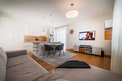 a living room with a couch and a table at Marijonų Apartamentai in Panevėžys