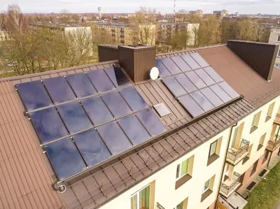 an overhead view of a roof with four solar panels on it at Marijonų Apartamentai in Panevėžys