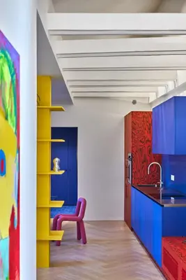 a kitchen with blue cabinets and a purple chair at Pop Haus Vilnius in Vilnius