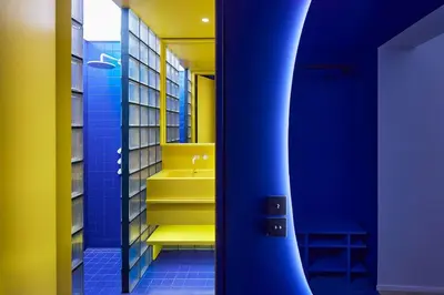 a bathroom with yellow and blue walls and yellow stairs at Pop Haus Vilnius in Vilnius