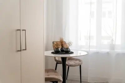 a table in a room with a window at Close to Old Town & Amenities 1 in Vilnius