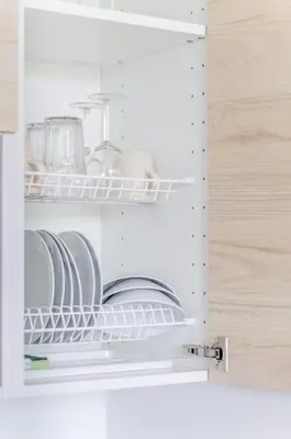 a cupboard with plates and dishes inside of it at Close to Old Town & Amenities 1 in Vilnius