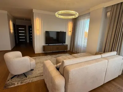 a living room with a couch and two chairs and a television at Luxury Oasis in the Heart of the City in Druskininkai