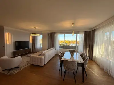 a living room with a couch and a table at Luxury Oasis in the Heart of the City in Druskininkai