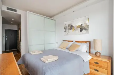 a bedroom with a bed with two towels on it at Studio in central Vilnius in Vilnius