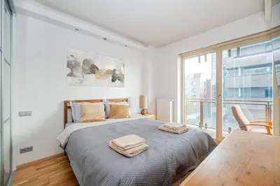a bedroom with a bed with two towels on it at Studio in central Vilnius in Vilnius