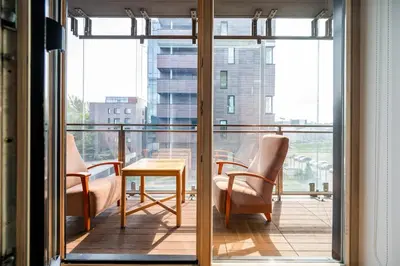 a room with two chairs and a table on a balcony at Studio in central Vilnius in Vilnius