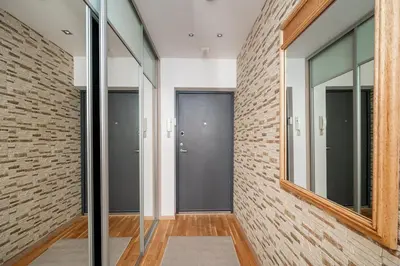 a hallway with glass doors and a brick wall at Studio in central Vilnius in Vilnius