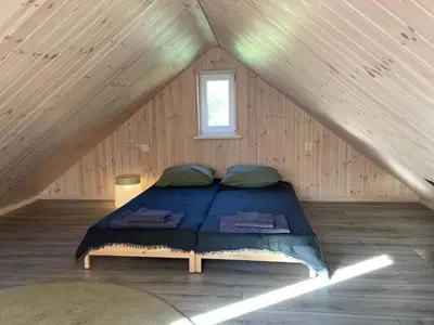 a bedroom with a bed in a attic at Peaceful lake retreat with sauna