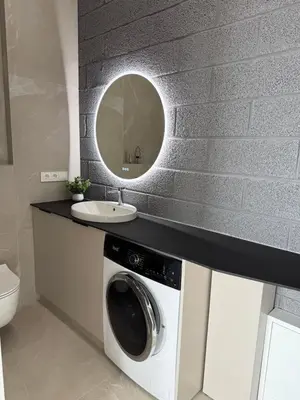 a bathroom with a washing machine and a sink at Cosy apartment near city centre in Kaunas