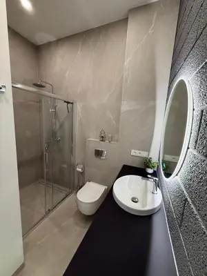 a bathroom with a toilet and a sink and a shower at Cosy apartment near city centre in Kaunas