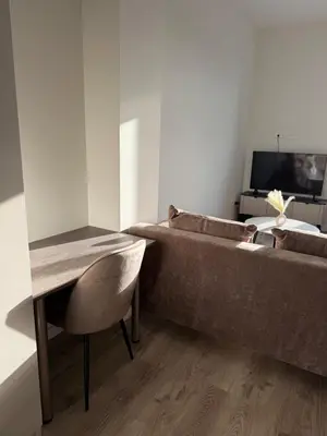 a living room with a couch and a table at Cosy apartment near city centre in Kaunas