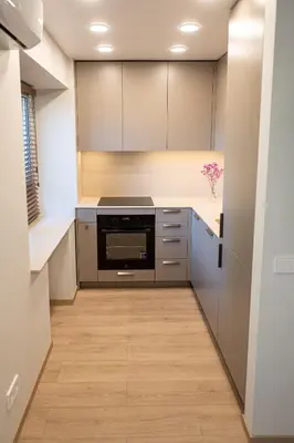 a kitchen with a refrigerator and a stove at Vytauto 12 - jaukūs apartamentai centre - Self Check-in in Marijampolė