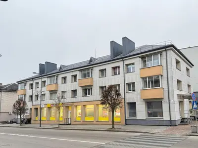 a large building on a city street with a street at Vytauto 12 - jaukūs apartamentai centre - Self Check-in in Marijampolė