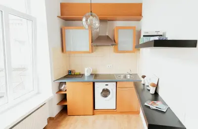 a kitchen with a washing machine and a sink at Gedimino Avenue Central Apartment in Vilnius