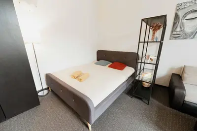 a small bedroom with a bed and a book shelf at Gedimino Avenue Central Apartment in Vilnius