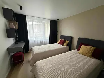 a hotel room with two beds and a window at Two Bedroom Apartment LAZDYNAI in Vilnius