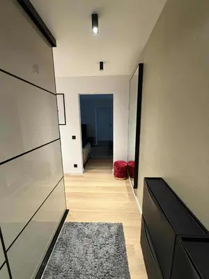a hallway leading to a room with a hallway at Two Bedroom Apartment LAZDYNAI in Vilnius