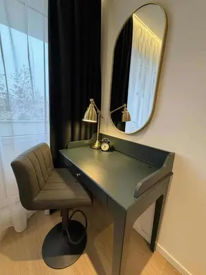 a desk with a lamp and a chair and a mirror at Two Bedroom Apartment LAZDYNAI in Vilnius